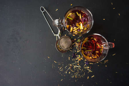Floral tea on dark wooden background with copysaceの写真素材