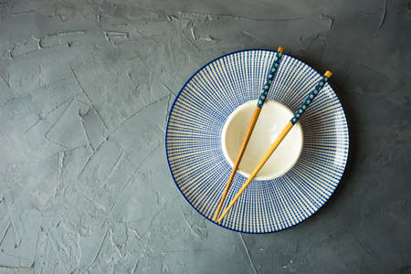 Table setting with flatware and chopsticks o concrete backgroundの写真素材