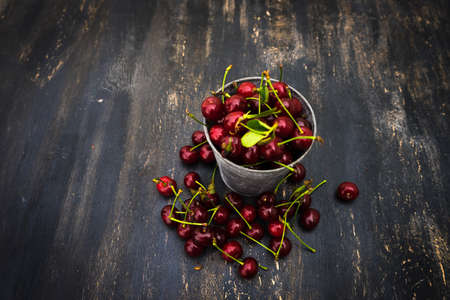 Fresh cherry berries on rustic wooden table and vintage backgroundの写真素材