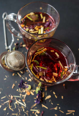 Floral tea on dark wooden background with copysaceの写真素材