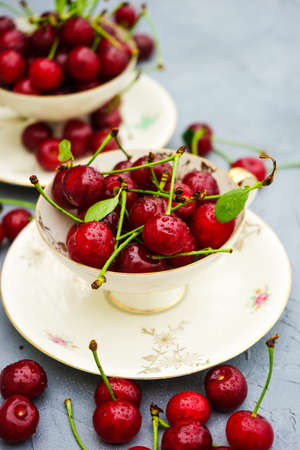 Fresh cherry berries on rustic concrete background