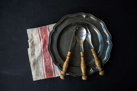 Rustic table setting with vintage flatware onn dark wooden tableの写真素材
