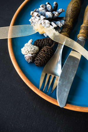 Table setting for Christmas dinner with festive decoration on dark wooden table with copyspaceの写真素材