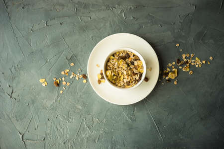 Healthy food concept with oatmeal and fruits on concrete backgroundの写真素材