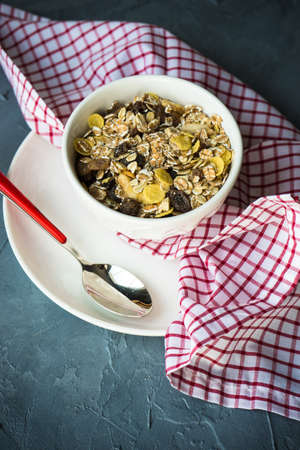 Healthy food concept with oatmeal and fruits on concrete backgroundの写真素材