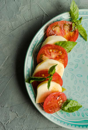 Traditional Mediterranean cuisine, Italian salad Caprese with tomatoes and cheese mozzarellaの写真素材