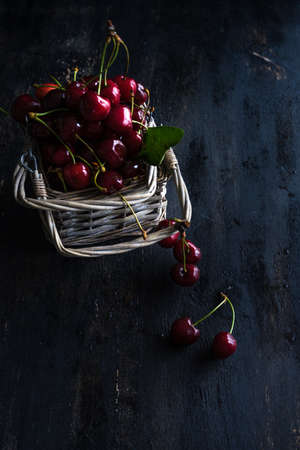 Organic food concept ripe red sweet cherries on dark wooden tableの写真素材