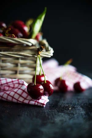 Organic food concept ripe red sweet cherries on dark wooden tableの写真素材