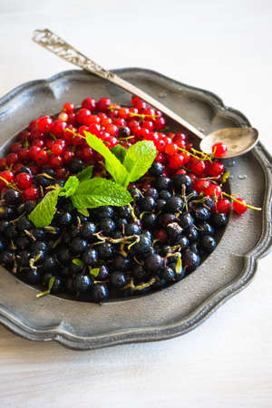 Ripe organic currant berries  on dark wooden table with copyspace as a organic food conceptの写真素材