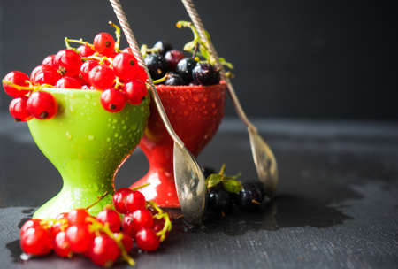 Ripe organic currant berries  on dark wooden table with copyspace as a organic food conceptの写真素材