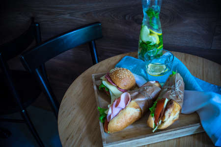 Snack concept with lemonade and cheeseburgers on dark backgroundの写真素材