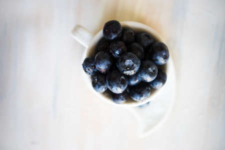 Ripe organic bilberries on dark wooden table with copyspace as a organic food conceptの写真素材