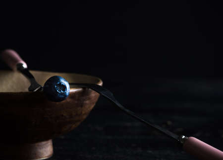 Ripe organic bilberries on dark wooden table with copyspace as a organic food conceptの写真素材