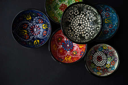Traditional turkish ceramic bowls on dark wooden backgroundの写真素材