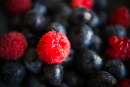 Fresh summer berries on white wooden rustic table with mint leavesの写真素材