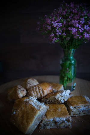 Traditional georgian sweet dessert - kada on the table decorated with summer flowersの写真素材