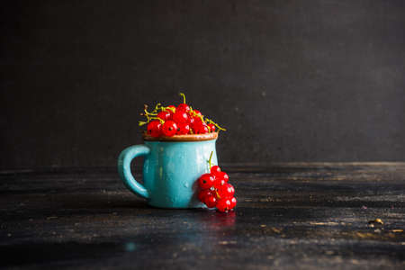 Ripe organic currant berries  on dark wooden table with copyspace as a organic food conceptの写真素材