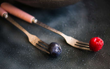 Fresh summer berries on white wooden rustic table with mint leavesの写真素材