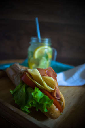 Snack concept with lemonade and cheeseburgers on dark background