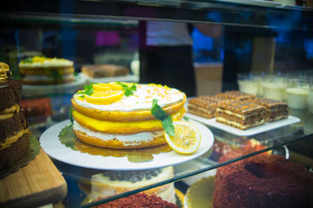 Lemon pie with bizet and marzipan decorated with flowers on dark wooden tableの写真素材