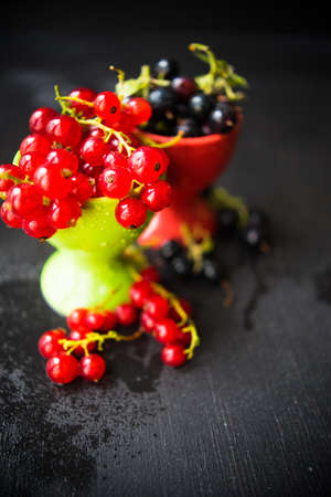 Ripe organic currant berries  on dark wooden table with copyspace as a organic food conceptの写真素材