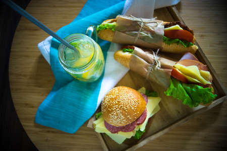 Snack concept with lemonade and cheeseburgers on dark backgroundの写真素材