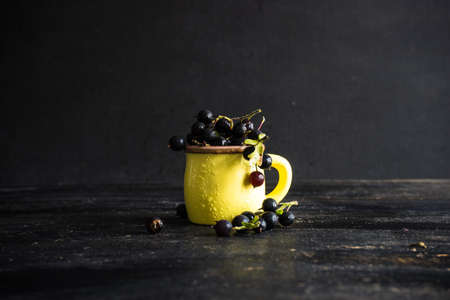 Ripe organic currant berries  on dark wooden table with copyspace as a organic food conceptの写真素材