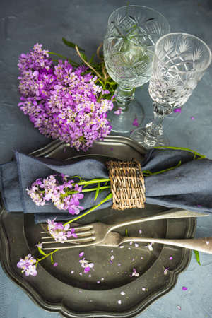 Summertime floral table setting with bright purple flowers with copysaceの写真素材