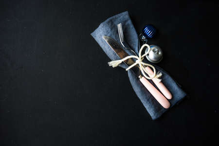 Christmas time table setting with vintage silverware on plate and napkinの写真素材
