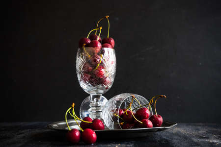 Organic food concept ripe red sweet cherries on dark wooden tableの写真素材
