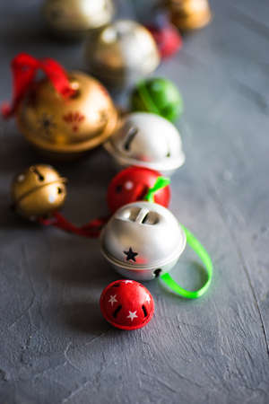 Christmas frame with christmas tree branches and jingle bells on grey concrete backgroundの写真素材
