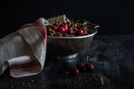 Organic food concept ripe red sweet cherries on dark wooden tableの写真素材