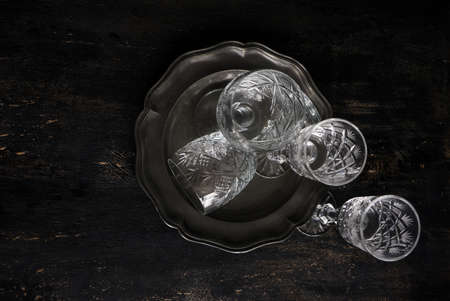 Vintage crystal glasses on the black tray with christmas decorations. Toned pictureの写真素材