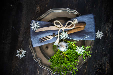 Festive table setting for Christmas dinner on dark rustic table with copyspaceの写真素材