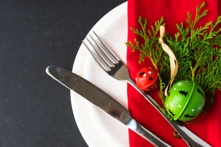 Festive table setting for Christmas dinner on dark rustic table with copyspaceの写真素材