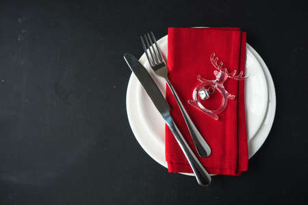 Festive table setting for Christmas dinner on dark rustic table with copyspaceの写真素材