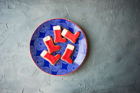 Festive gingerbread cookies for Christmas holiday celebration on ceramic plate on concrete background with copyspaceの写真素材