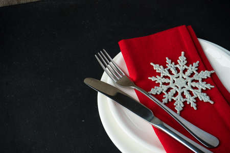 Festive table setting for Christmas dinner on dark rustic table with copyspaceの写真素材