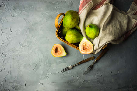 Organic fig tree fruits on the vintage plate on concrete background with copyspaceの写真素材