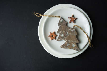 Festive table setting for Christmas dinner on dark rustic table with copyspaceの写真素材