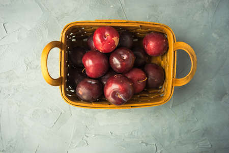 Fresh organic plums  on old rustic wooden tableの写真素材