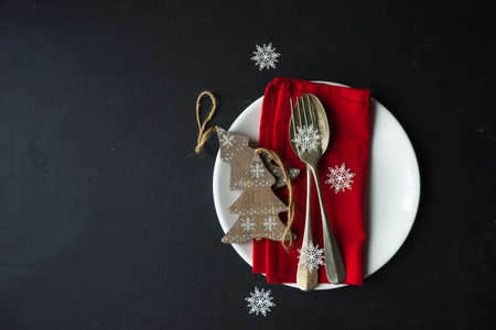 Festive table setting for Christmas dinner on dark rustic table with copyspaceの写真素材