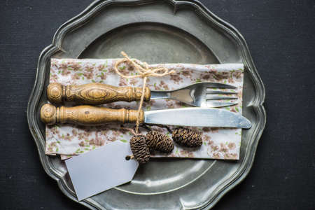 Autumnal table setting with acorns and rustic plates on concrete tableの写真素材