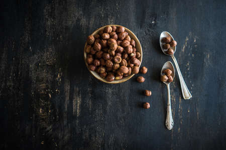 Organic nuts on dark wooden table with copyspace