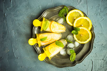 Summer dessert with lemon and mint on rustic wooden background with copyspaceの写真素材