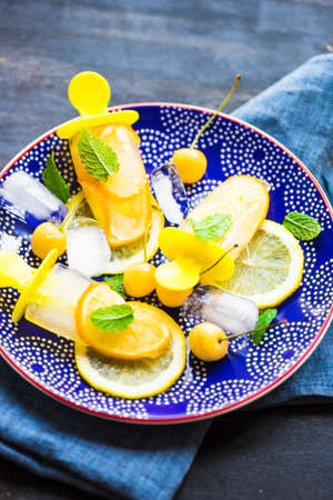 Summer dessert with lemon and mint on rustic wooden background with copyspace