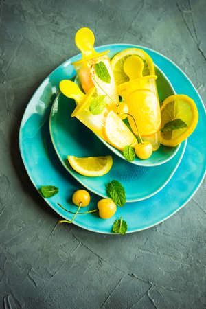 Summer dessert with lemon and mint on rustic wooden background with copyspaceの写真素材