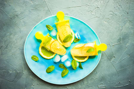 Summer dessert with lemon and mint on rustic wooden background with copyspaceの写真素材