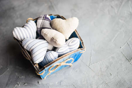 busket full of hearts on rustic concrete background with copyspaceの写真素材