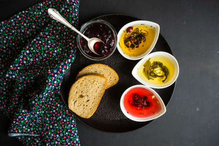 Different types of tea, green tea, peony and ginger tea, rose bud and wild flowers tea on dark wooden background with copyspaceの写真素材